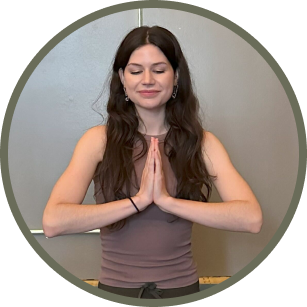 Woman in peaceful yoga position and hands in prayer position.